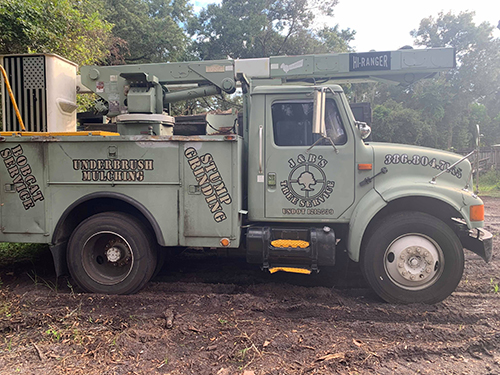 J&B's Tree Service bucket truck, stump grinding and underbrush mulching truck